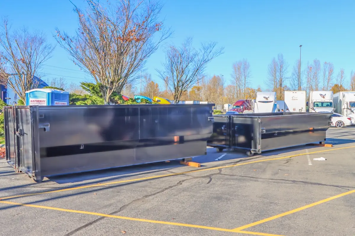 Professional dumpster rental service with roll-off container on residential driveway in Cuyahoga Falls